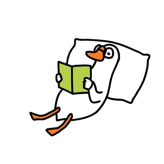 duck reading book while leaning on a pillow